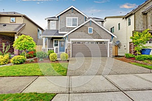 Nice curb appeal of two level house, mocha exterior paint and concrete driveway