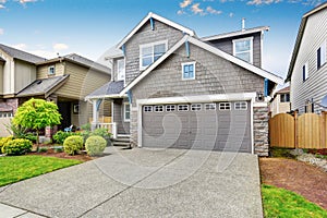 Nice curb appeal of two level house, mocha exterior paint and concrete driveway