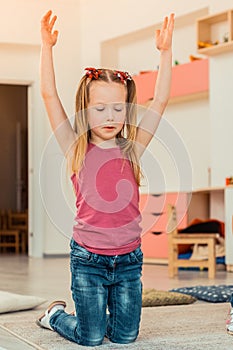 Nice cute girl holding her hands up