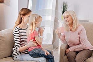 Nice delighted grandmother talking to her granddaughter