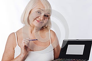 Nice delighted woman applying eyeshadow