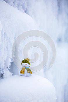 Nice dreaming snowman in green hat.