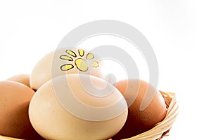 Nice eggs with sun sign in basket