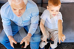 Nice elderly man playing video games