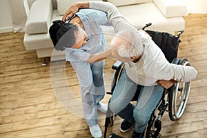 Nice elderly man using caregivers help