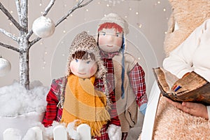 A nice elderly woman sews to knit her granddaughters in a Christmas arrangement