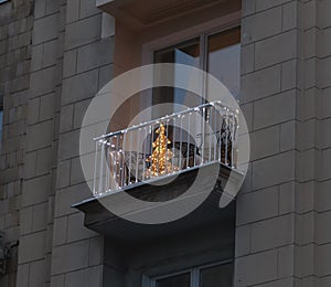 Nice electrovalence in form of Christmas tree on balcony at dusk