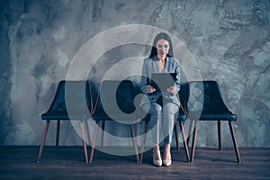 Nice elegant stylish trendy chic top executive manager brunette lady sitting waiting appointment at industrial loft