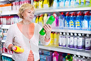 Nice female choosing household chemical goods
