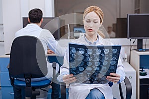 Nice female doctor examining X ray image