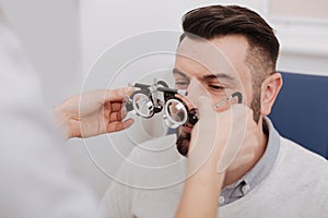 Nice female doctor giving eye test glasses to her patient