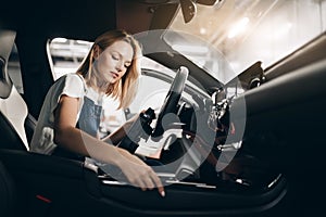 Nice female mechanic working with tablet at the garage