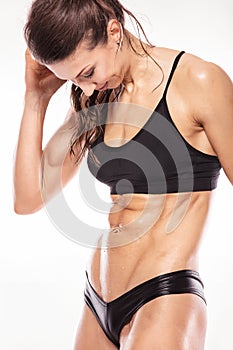 Nice fitness woman showing abdominal muscles