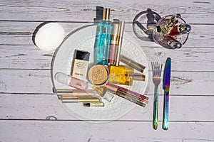 Nice, FRANCE - 21.05.2021 Aesthetic photo. Cosmetic makeup set on the plate on the table as lunch. Powder, lipstick