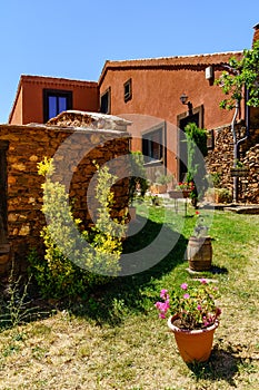 Nice garden of old house with colorful plants and flowers at the entrance. Spain photo