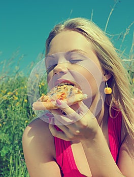 Nice girl eats pizza. lunch