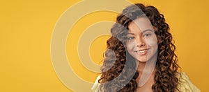 nice girl has wavy hairdo. portrait of frizz child. express positive emotion. Child face, horizontal poster, teenager