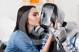 Nice girl kissing robot