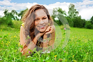 Nice girl laying on green grass