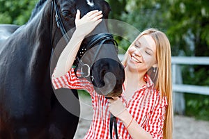 Nice girl palming purebred horse