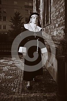 Nice girl posing like sad nun