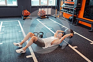 Nice good looking man lifting a black ball