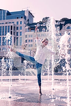 Nice graceful young woman feeling the water