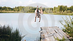 Nice guy jumping off the dock into the lake. Delayed frames. It's very beautiful.