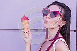 Nice happy Asian woman holding ice cream