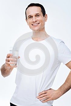 Nice happy man drinking water