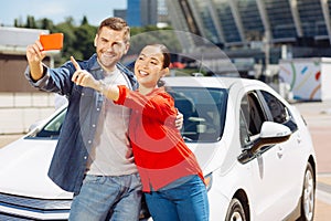 Nice happy woman pointing at the smartphone screen