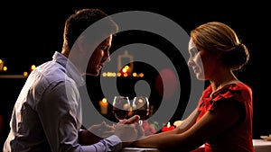 Nice husband and wife having romantic dinner in restaurant, night for two