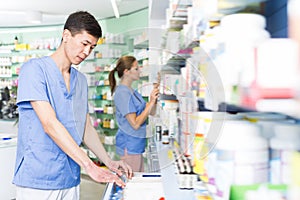 Nice japan man is searching medicines on shelves