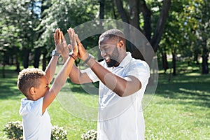 Nice joyful father and son expressing their happiness