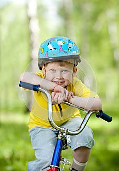 Nice kid weared in helmet on bicycle