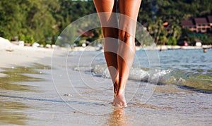 Nice legs walking on the beach