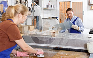 Nice man and woman working on washing machine