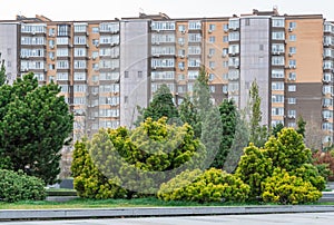 Nice modern leisure city park with benchs surrounded high-rise building.