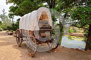 Nice old covered wagon in Arizona and lake in background