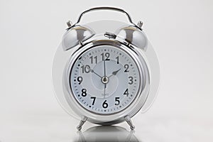 Nice old vintage chrome metal twin bell alarm clock on white background
