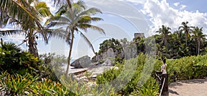 Nice panoramic view of a woman admiring the Mayan ruins and the beach of Tulum, which is a pre-Columbian city and is located in