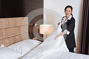 Nice pleasant woman cleaning the hotel room