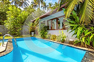 Nice pool in backyard of luxury tropical hotel or residential house