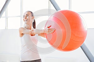 Nice positive woman exercising with a fitness ball