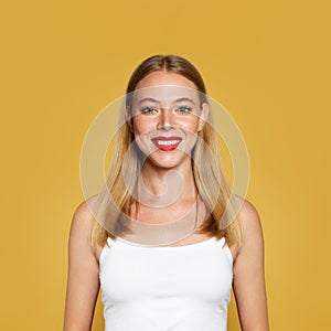 Nice positive woman on yellow background. Portrait, positive emotion