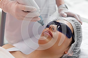 Nice pretty woman having a laser facial epilation