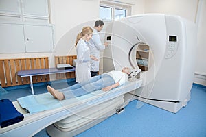 Nice professional doctors using a CT scanner