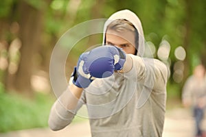 Nice punch. Boxing training endurance. Man athlete concentrated face with sport gloves practicing boxing nature