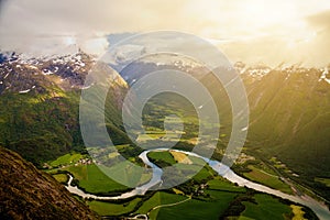 River meanders around fields seen from Romsdalseggen ridge, Andalsnes, Norway photo