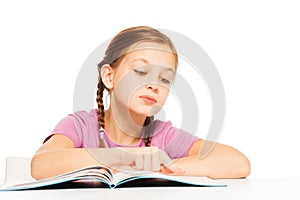 Nice schoolgirl is reading interesting book